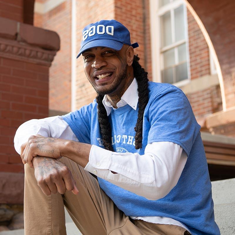 Floyd Ezell, Bright College student sitting on the steps in front of Old Main.